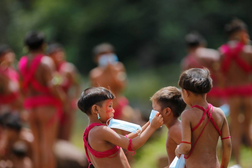 A child from the indigenous Yanomami ethnic group holds a protective face mask at the 4th Surucucu Special Frontier Platoon of the Brazilian army in the municipality of Alto Alegre, state of Roraima, Brazil July 1, 2020. REUTERS Photo